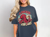 T-shirt with octopus holding cake, text "A sucker for cake".