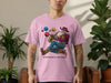 Pink t-shirt with skeleton playing saxophone surrounded by planets, text "PLANETARY REMAINS".