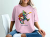 Chameleon wearing sunglasses plays electric guitar on pink t-shirt.