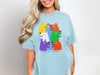 Light blue t-shirt with colorful cartoon dogs saying "DO NOT LET THEM DRIVE".
