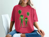 Red t-shirt with neon green alien outlines holding balloons.
