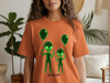 Orange t-shirt with green alien graphic and "NOT FROM HERE" text.