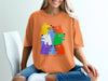 Orange t-shirt with colorful cartoon dogs and "DO NOT LET THEM DRIVE" text.