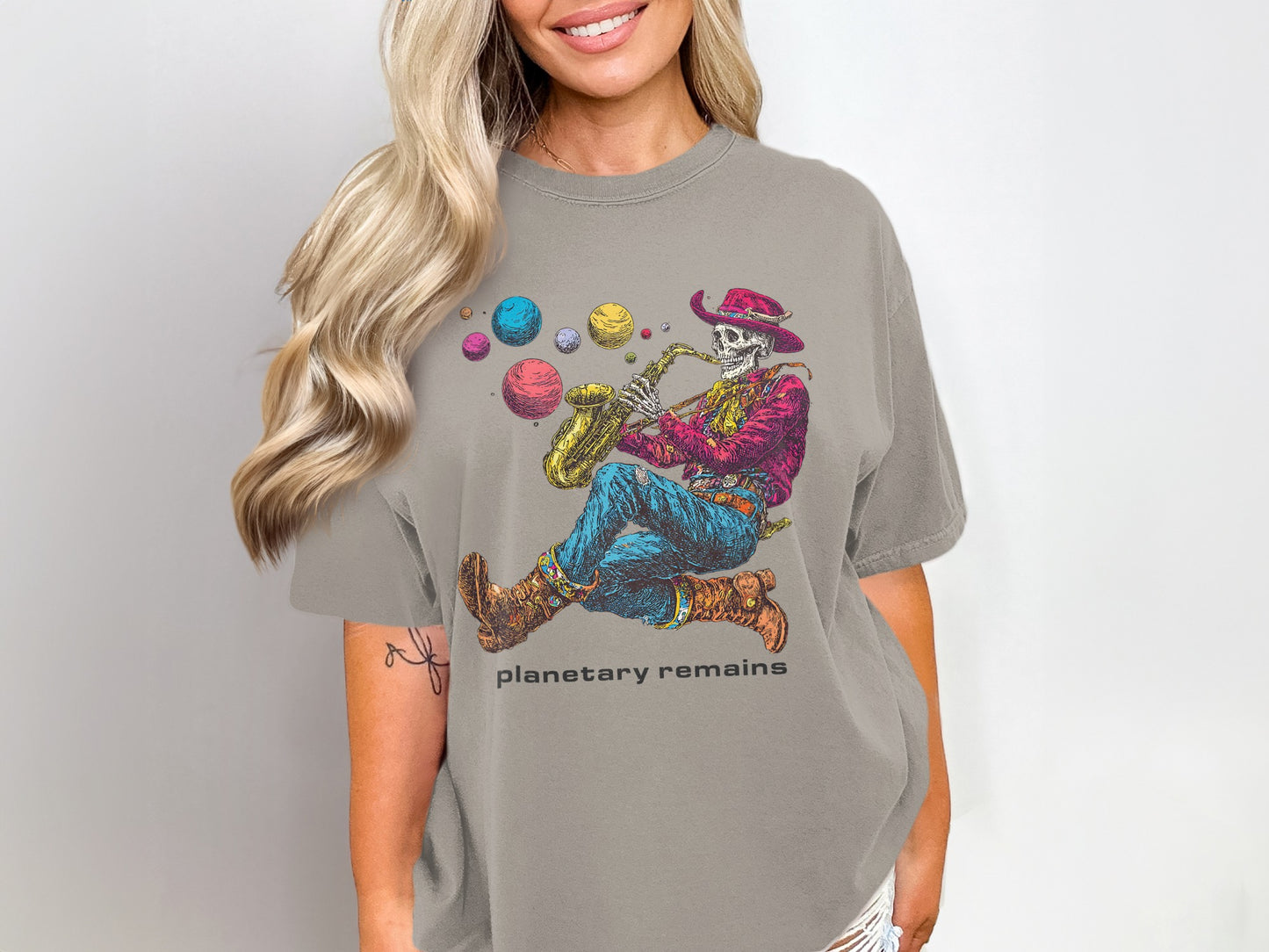 Skeleton playing saxophone wearing cowboy hat and boots, with planets in background.