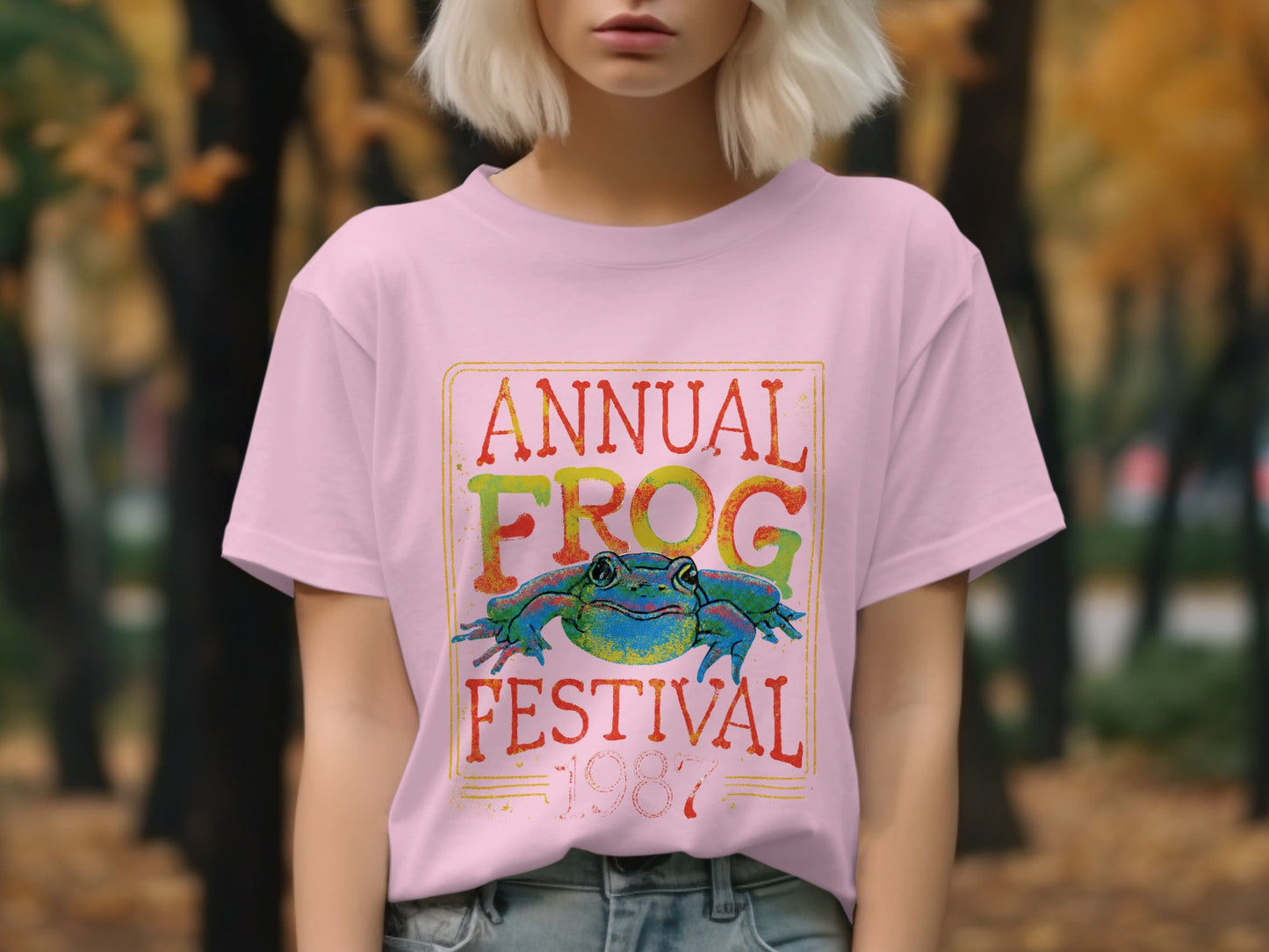Pink t-shirt with "Annual Frog Festival" text and a colorful frog graphic.