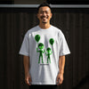 White t-shirt with green alien graphics and "NOT FROM HERE" text.