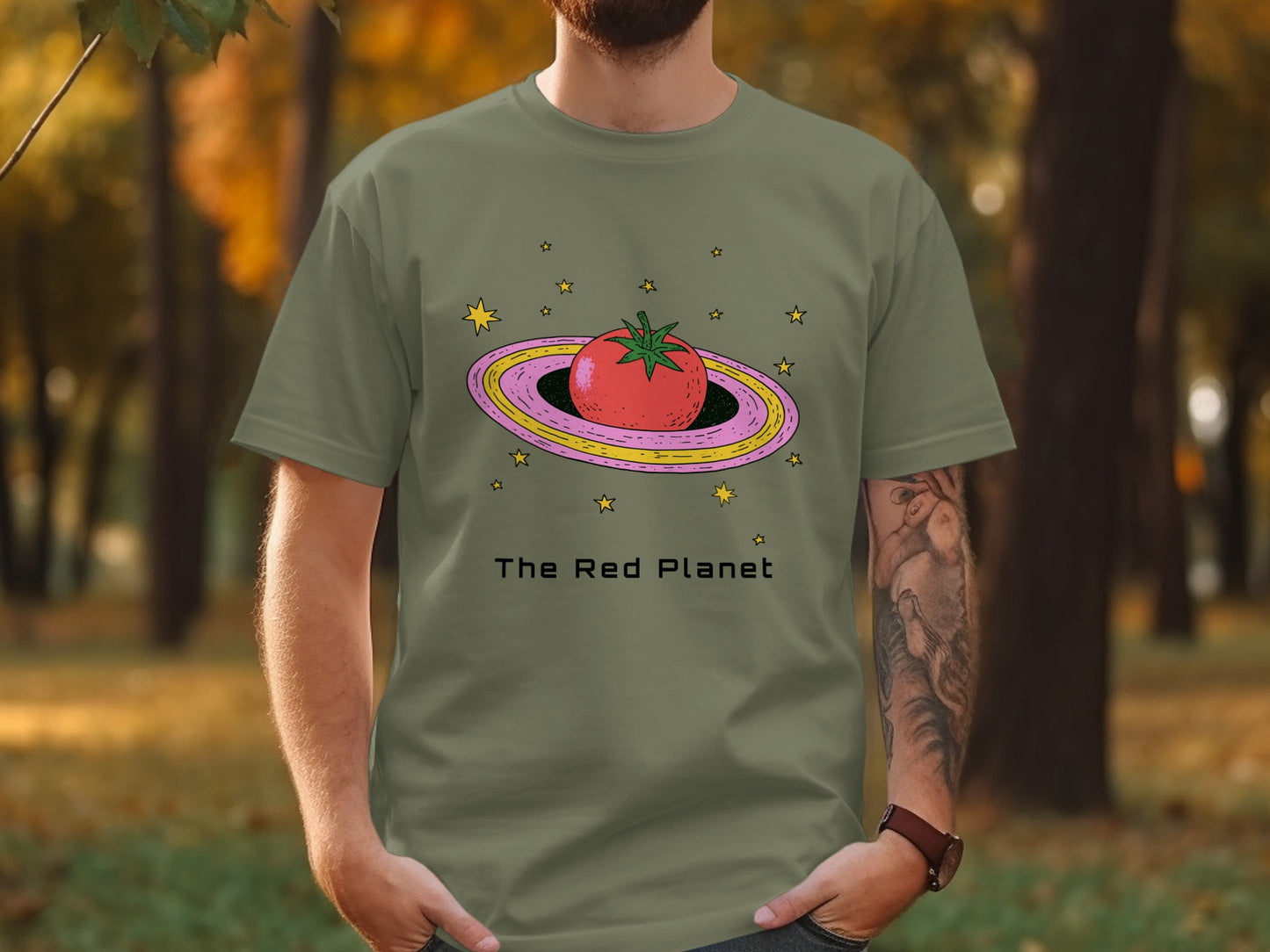 T-shirt with a tomato and stars orbiting a ringed planet.