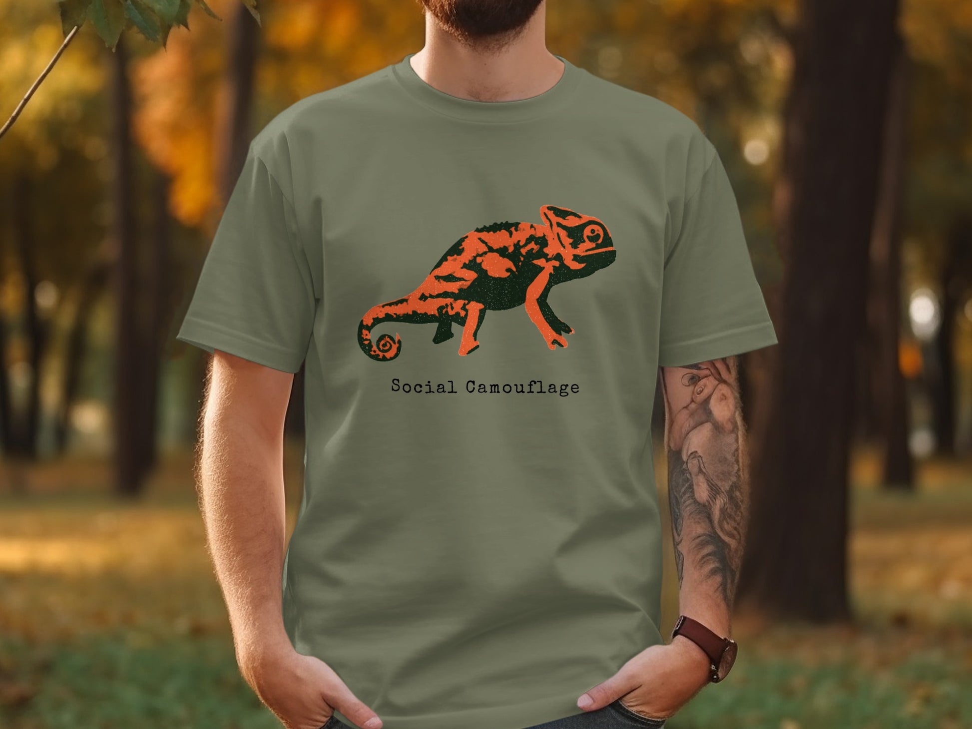 Green t-shirt with "Social Camouflage" text and a stylized orange chameleon graphic.