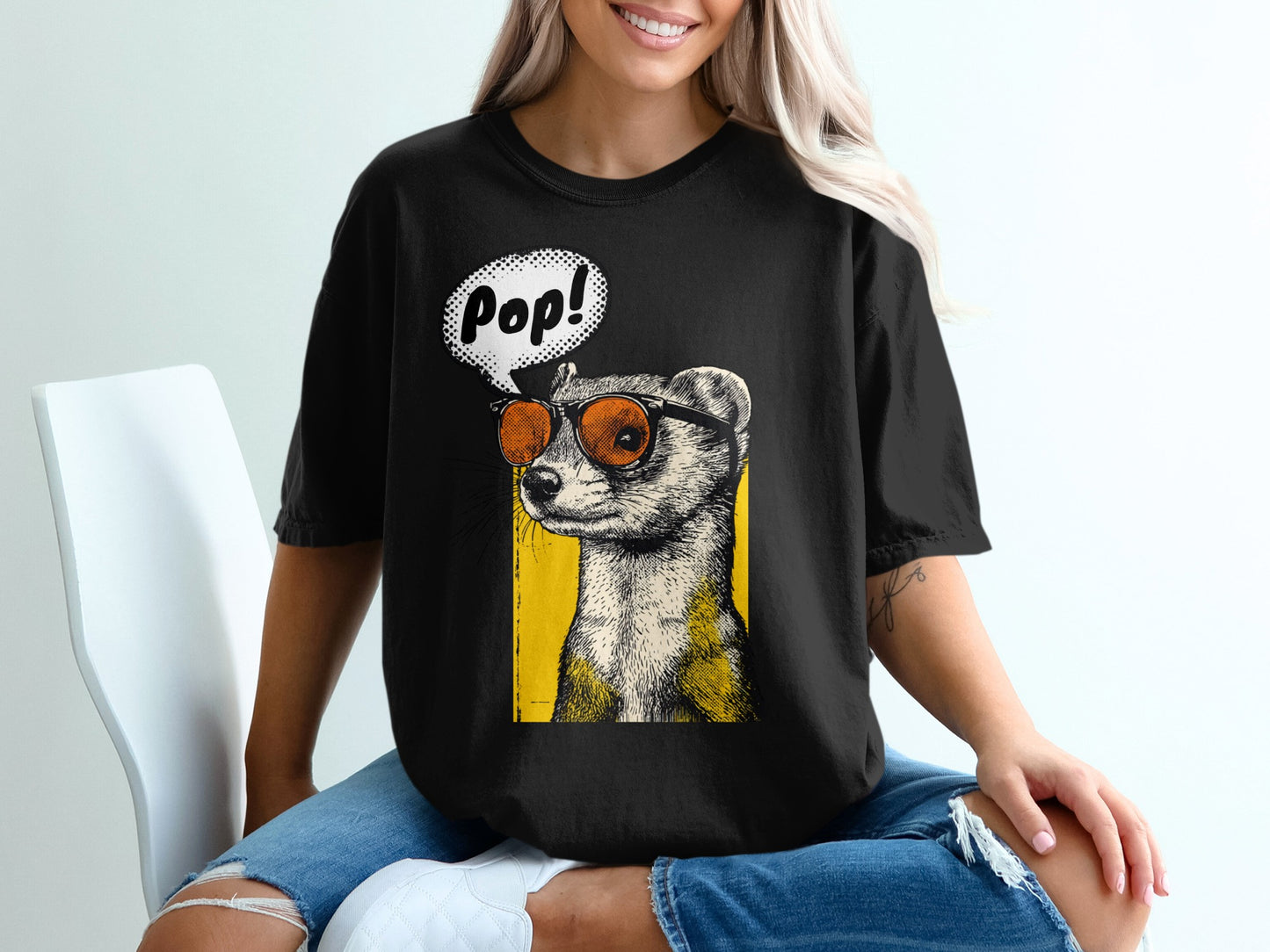 Black t-shirt with a graphic of a ferret wearing sunglasses and a speech bubble saying "Pop!"