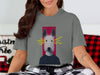 Grey t-shirt with a dog illustration wearing a dark sweater and lightning bolts from eyes.