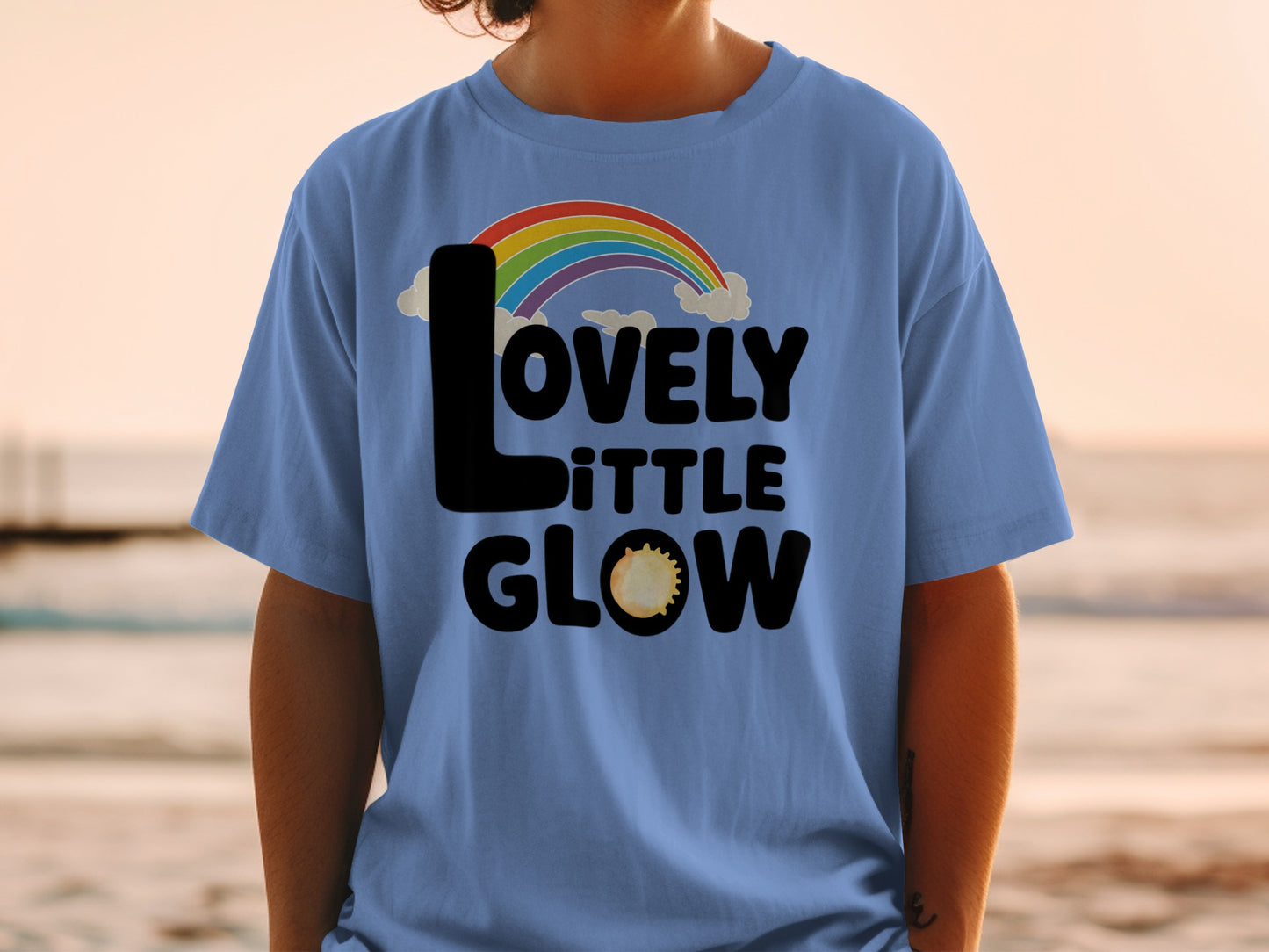 Blue t-shirt with "LOVELY little GLOW" and rainbow design.
