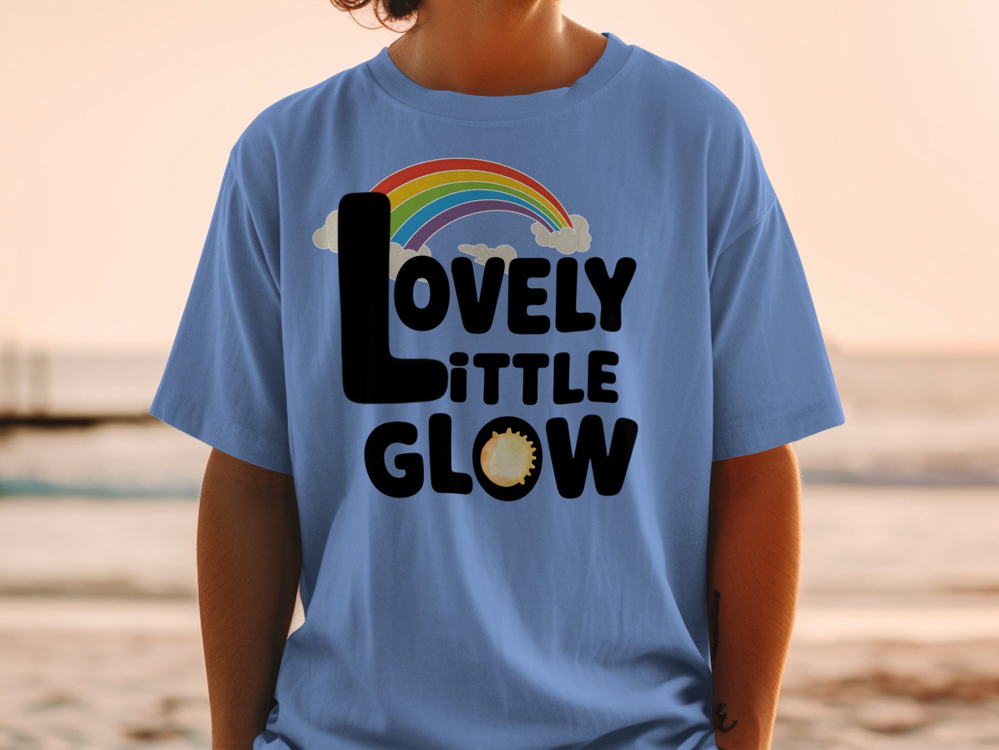 Blue t-shirt with "LOVELY little GLOW" and rainbow design.
