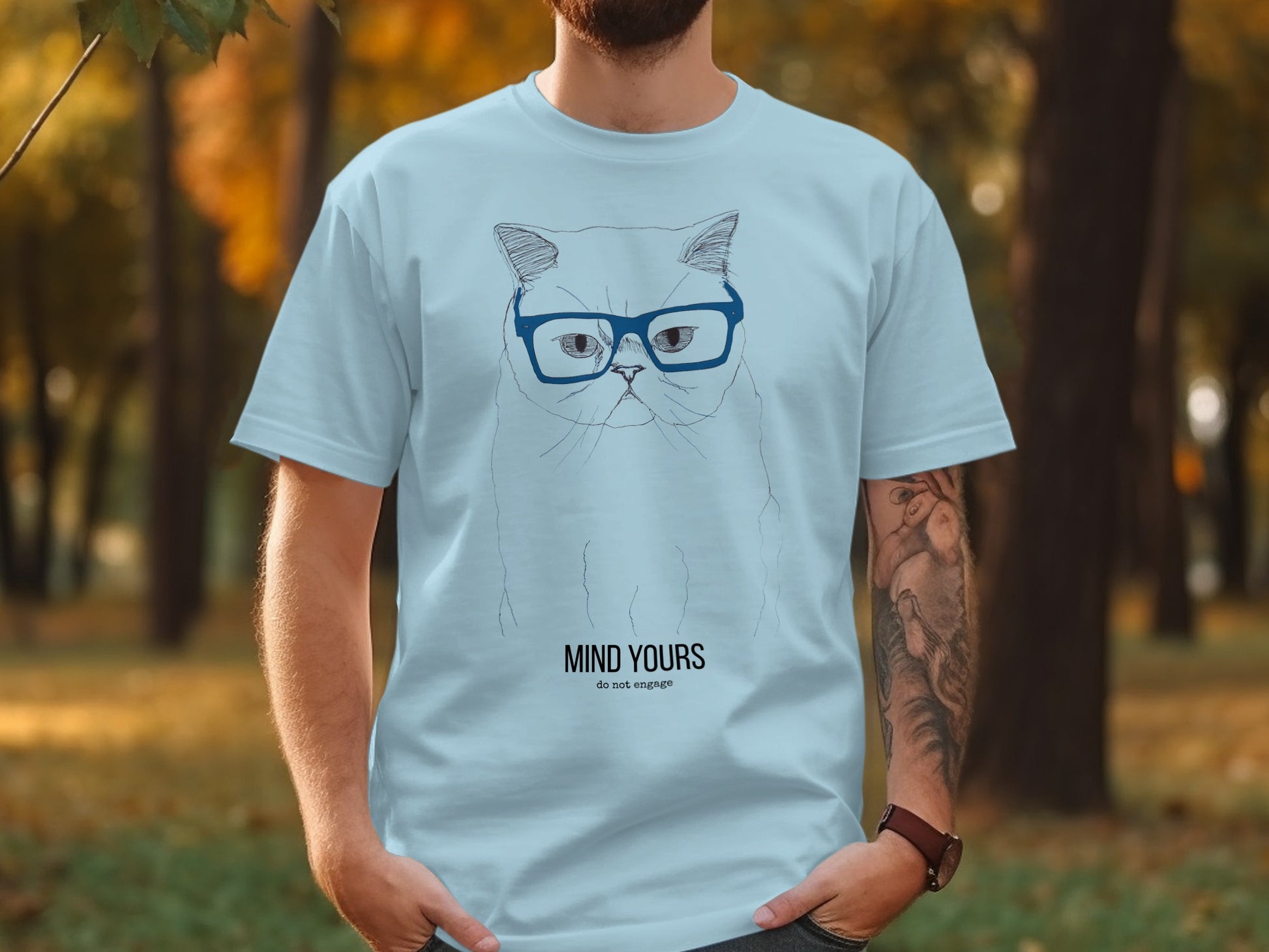 Light blue t-shirt with a cartoon cat wearing glasses and "MIND YOURS do not engage" text.