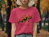 Pink t-shirt with orange chameleon graphic and "Social Camouflage" text.