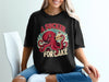 Black t-shirt with octopus holding cake and text "A SUCKER FOR CAKE".