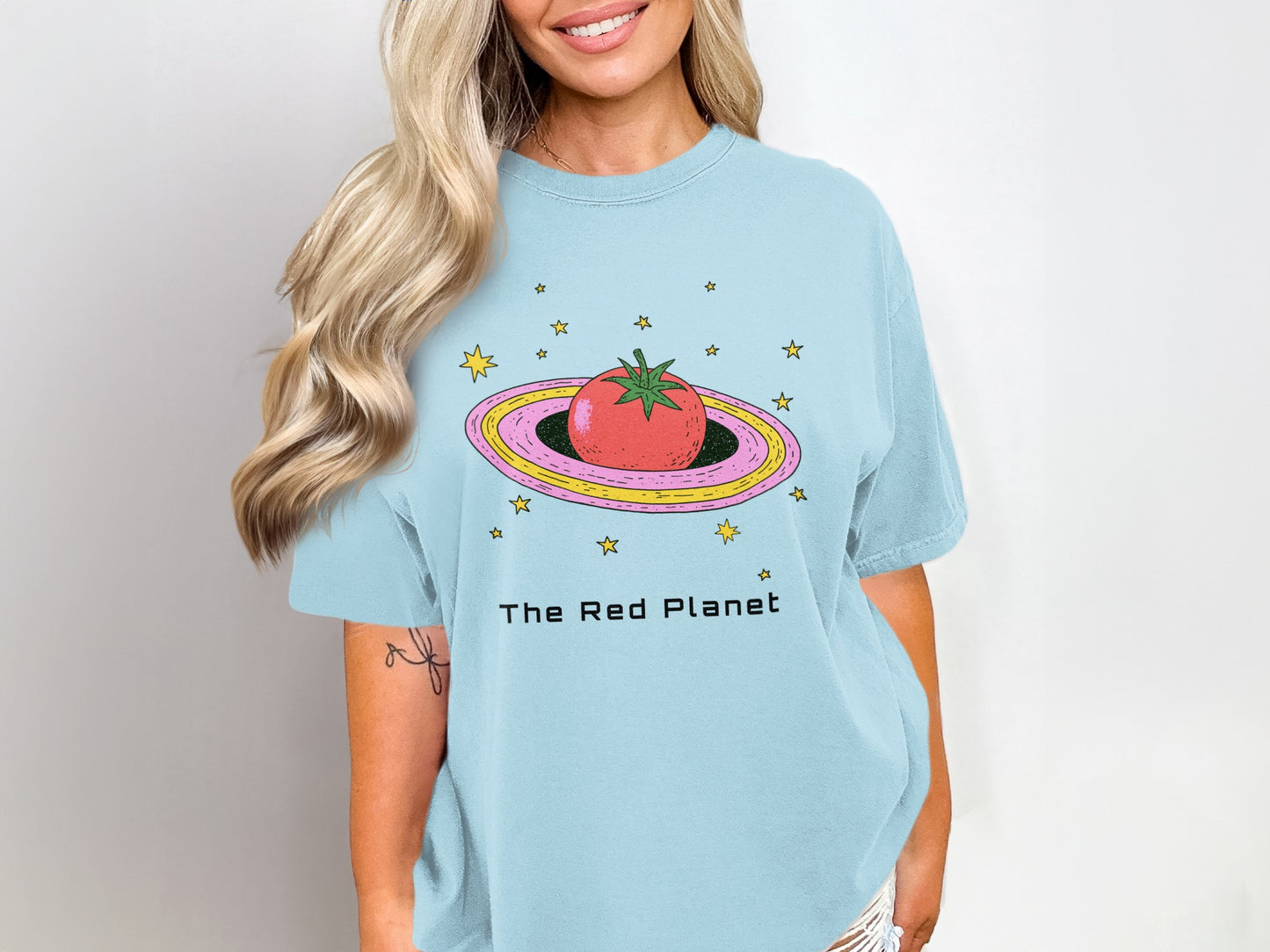 Light blue t-shirt with cartoon tomato and stars, reads "The Red Planet".