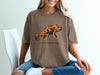 Brown t-shirt with orange chameleon graphic and "Social Camouflage" text.