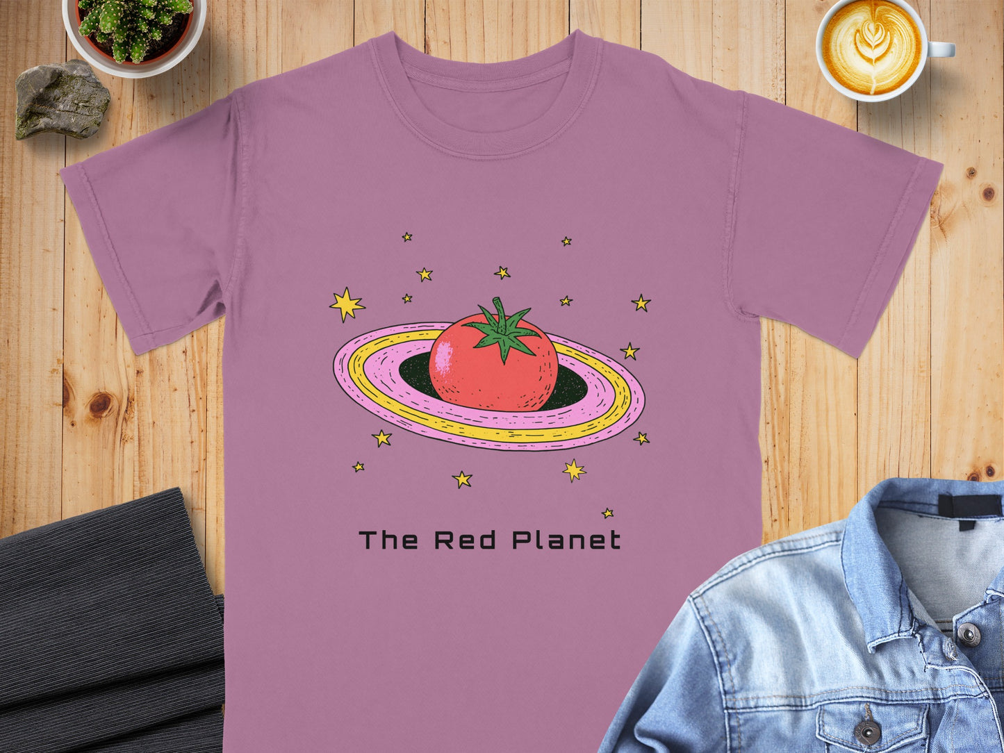 Pink t-shirt with a red tomato planet illustration and "The Red Planet" text.