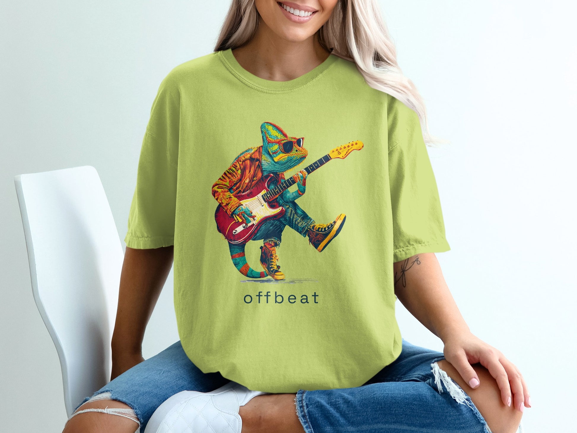 Chameleon playing guitar on a lime green t-shirt, "offbeat" text below.