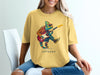 Yellow t-shirt with a colorful chameleon playing a red electric guitar.