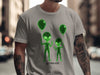 Green wireframe aliens with balloons, text reads "NOT FROM HERE".