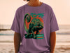 Chameleon graphic t-shirt with Japanese text and a sunset beach background.