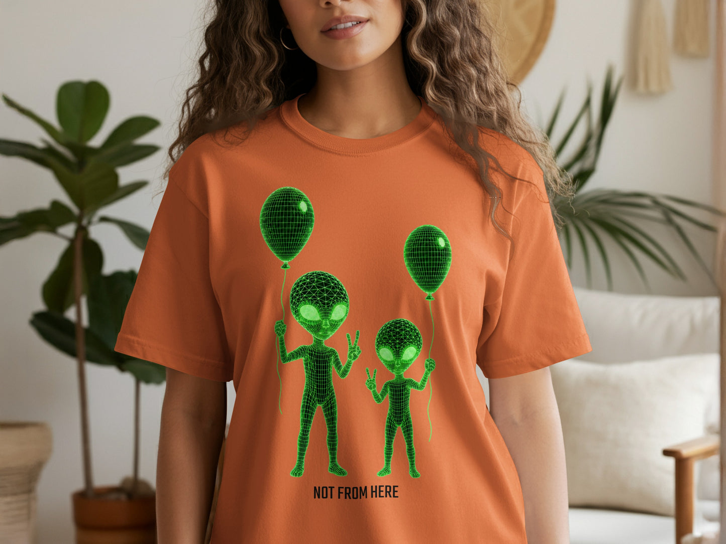 Orange t-shirt with green alien graphic and "NOT FROM HERE" text.