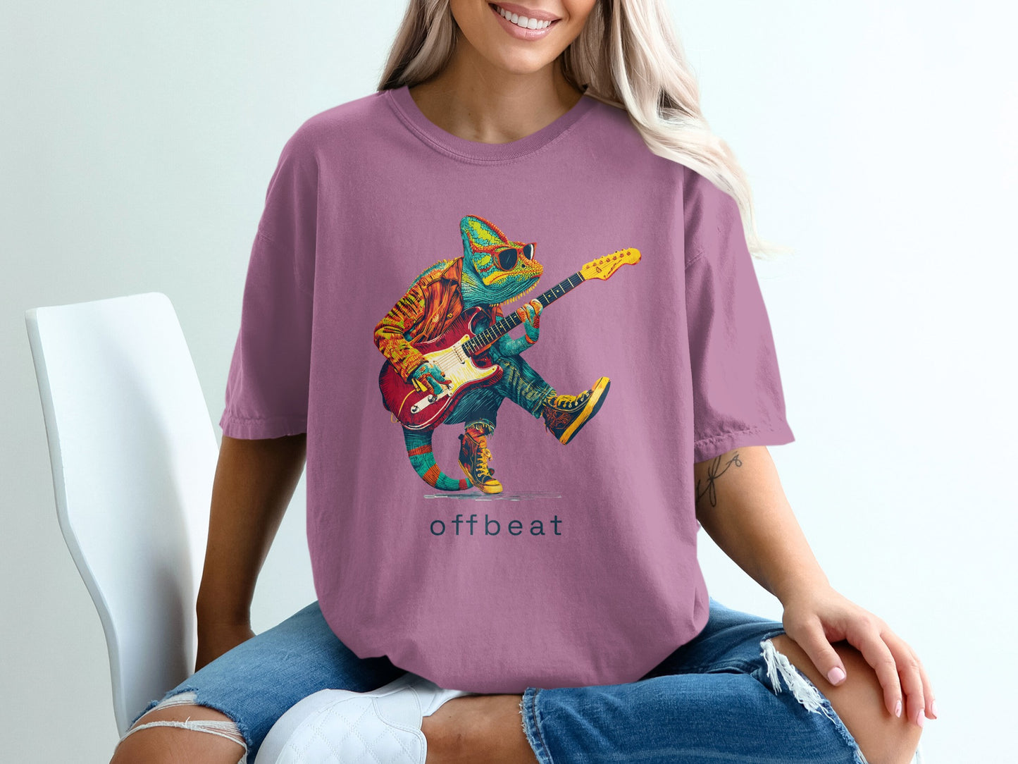 Chameleon wearing sunglasses and playing guitar, "offbeat" text on t-shirt.