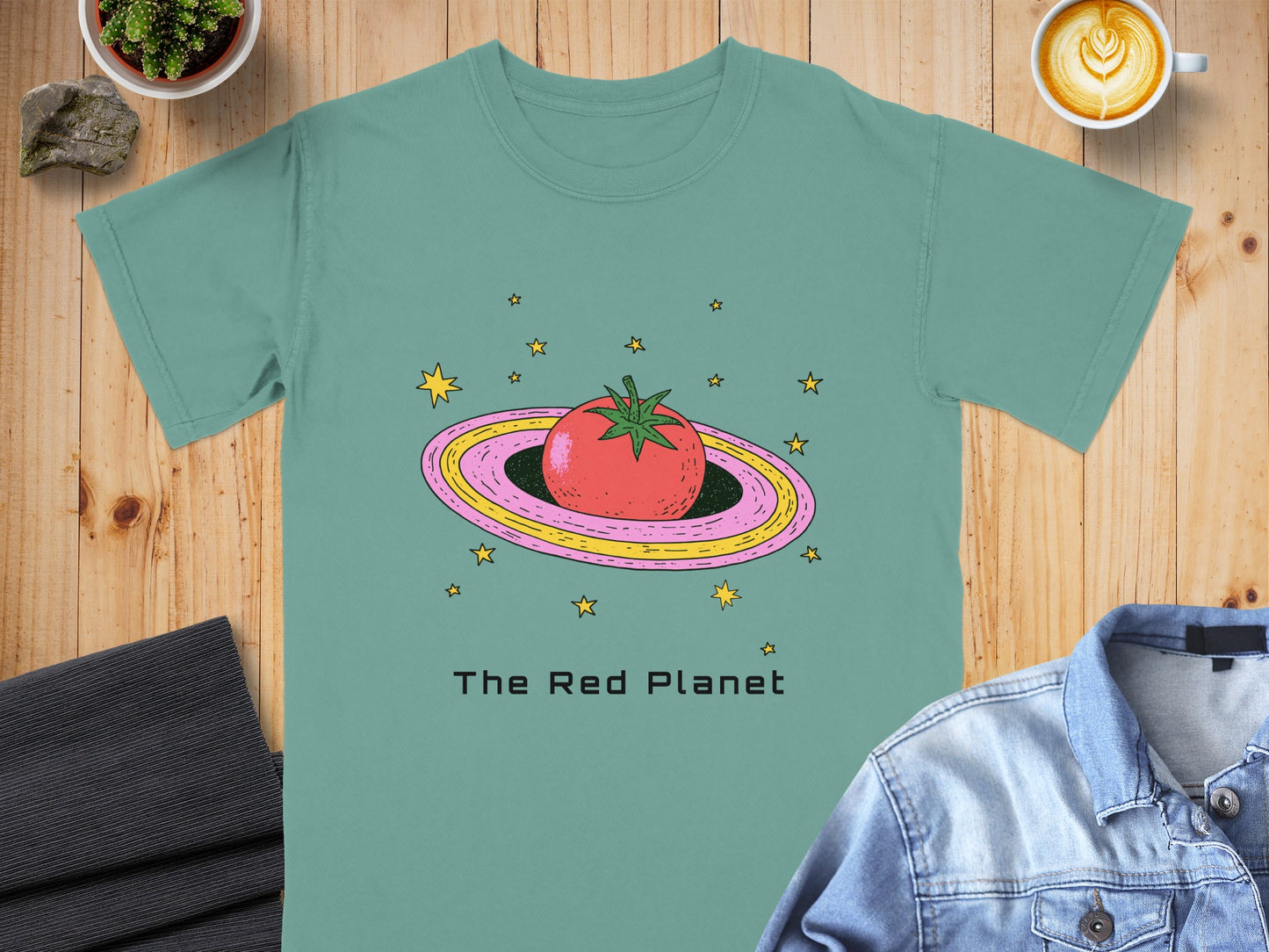 Teal t-shirt with a cartoon tomato on a ringed planet and "The Red Planet" text.