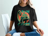 Black t-shirt with a teal chameleon and Japanese text.