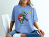 Chameleon wearing sunglasses playing a guitar on a blue t-shirt.